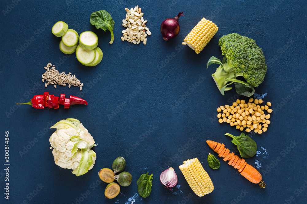 World vegan day. Frame of Fresh vegetarian ingredients for cooking vegan plate on dark background overhead view World vegan day. Frame of Fresh vegetarian ingredients for cooking vegan plate on dark background overhead view