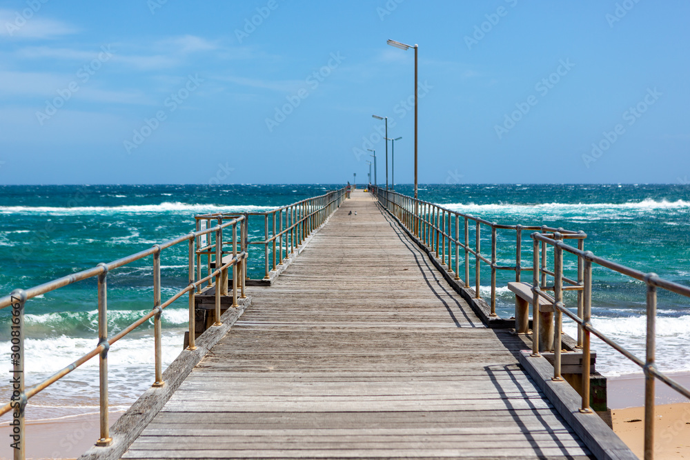 The Port Noarlunga Jetty with rough seas in Adelaide South Australia on 6th November 2019