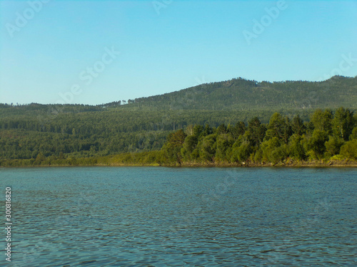 Beautiful river in the forest. Beautiful landscape with mountain river and taiga forest. The Ingoda river in the Russian far East. photo