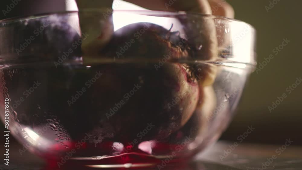 Cook takes boiled beets from a glass cup Cook takes boiled beets from a glass cup