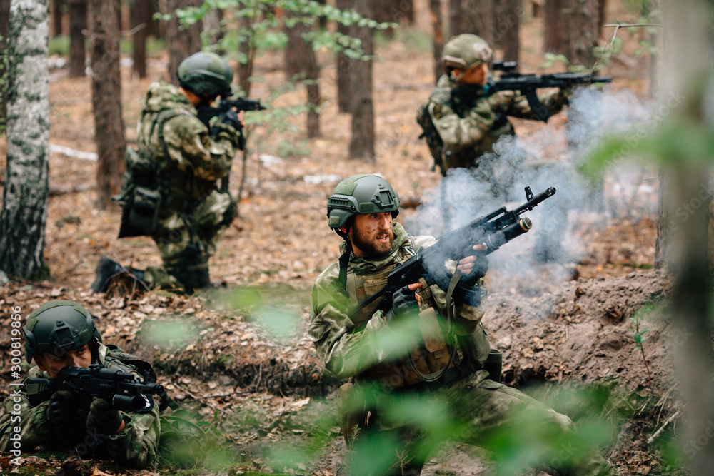 Soldiers in a combat situation. Men play airsoft.