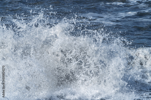 Sea wave off the coast. Splashing water © mazurevanasta