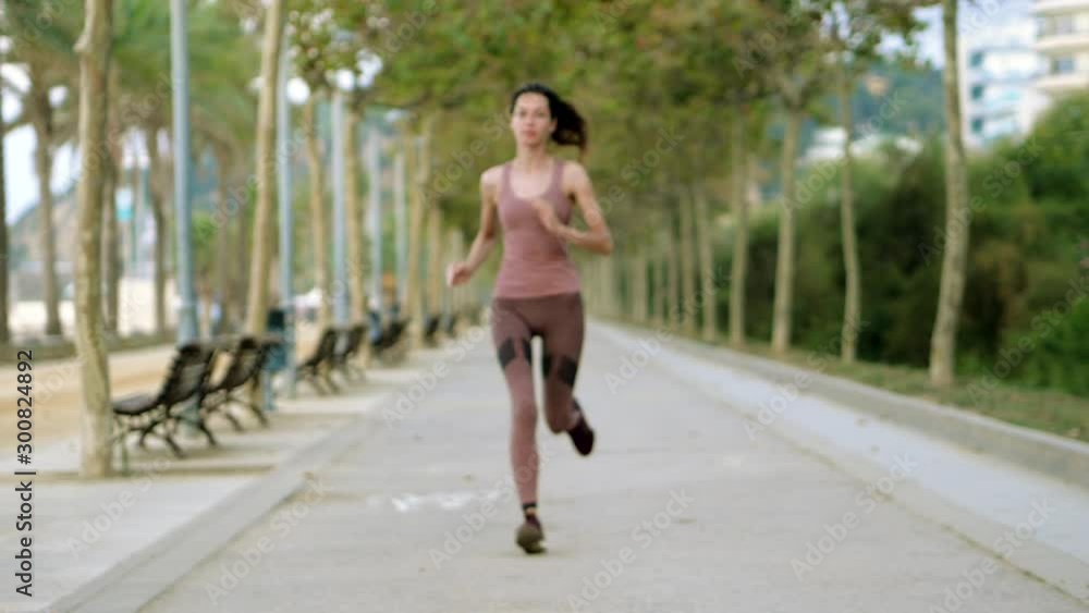 Coast of Costa del Maresme. Young beautiful woman with a slim body running along the coast of Mediterranean sea at sunrise. Calella. Barcelona. Spain. Slow motion. HD Coast of Costa del Maresme. Young beautiful woman with a slim body running along the coast of Mediterranean sea at sunrise. Calella. Barcelona. Spain. Slow motion. HD