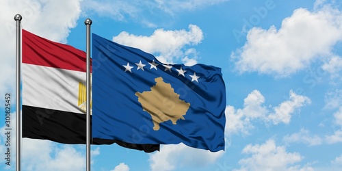 Egypt and Kosovo flag waving in the wind against white cloudy blue sky together. Diplomacy concept, international relations.