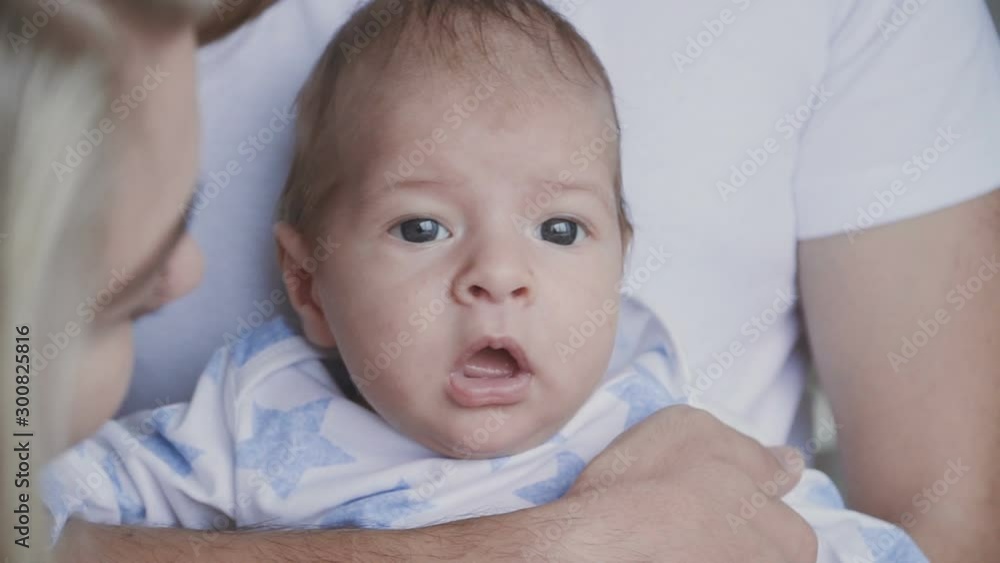 Happy young family - young father holding her new born son, kissing and hugging. Happy family concept. Slowmotion video. Happy young family - young father holding her new born son, kissing and hugging. Happy family concept. Slowmotion video.