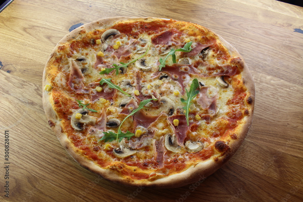 Calabrian pizza with ham, mushroom and cheese on a white plate. Calabrian pizza with ham, mushroom and cheese on a white plate.