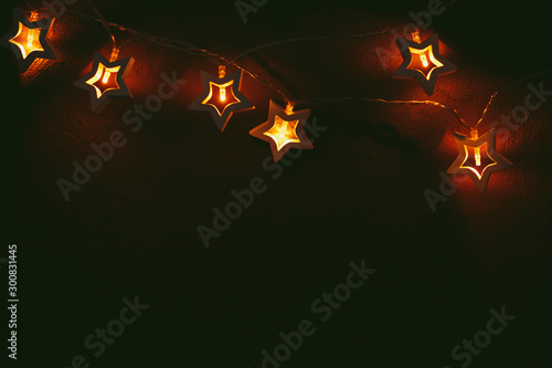 Beautiful bokeh light of star shaped garland in the dark