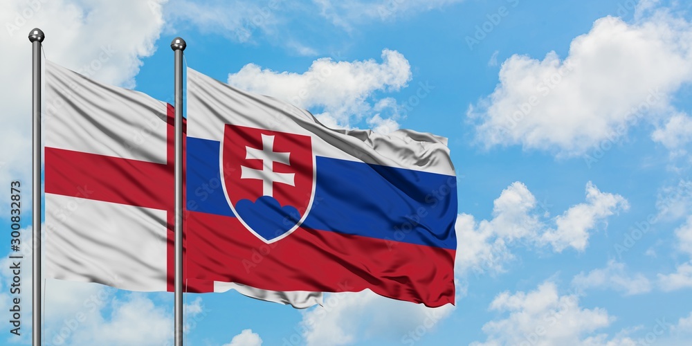England and Slovakia flag waving in the wind against white cloudy blue sky together. Diplomacy concept, international relations.