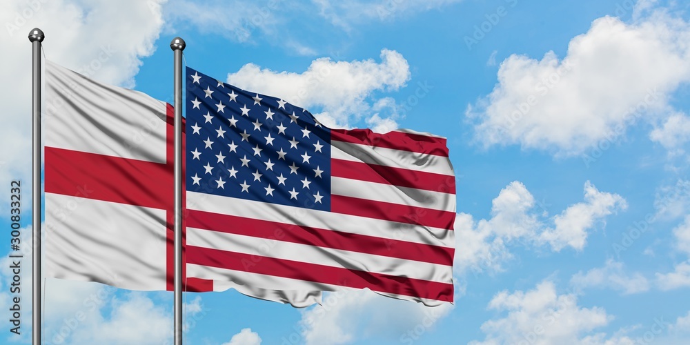 England and United States flag waving in the wind against white cloudy blue sky together. Diplomacy concept, international relations. England and United States flag waving in the wind against white cloudy blue sky together. Diplomacy concept, international relations.