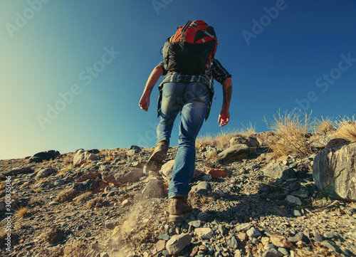 Hiker or backpacker goes uphill