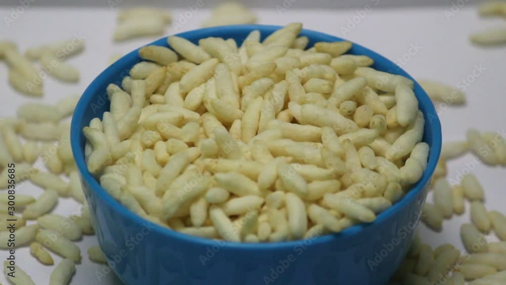 Puffed rice on the blue bowl with white background Puffed rice on the blue bowl with white background