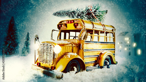 Christmas eve snow scene with yellow bus photo