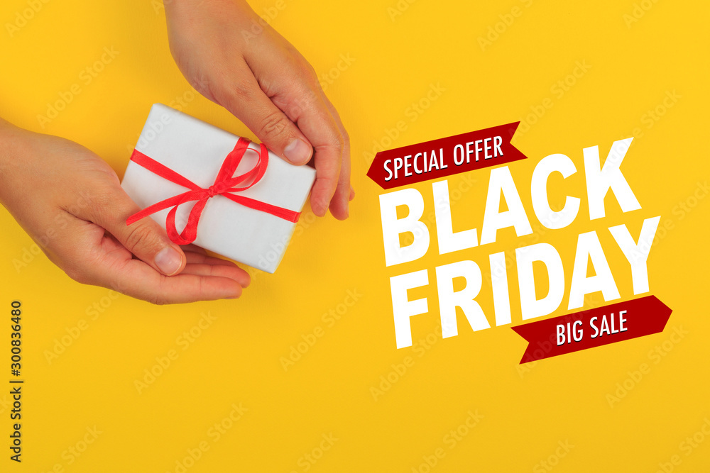 gift in female hands on a colored background top view. Black friday sale- Image gift in female hands on a colored background top view. Black friday sale- Image