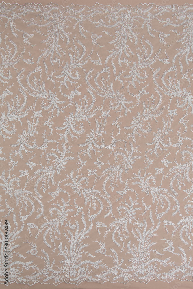 Fototapeta premium Texture lace fabric. lace on white background studio. thin fabric made of yarn or thread. a background image of ivory-colored lace cloth. White lace on beige background.
