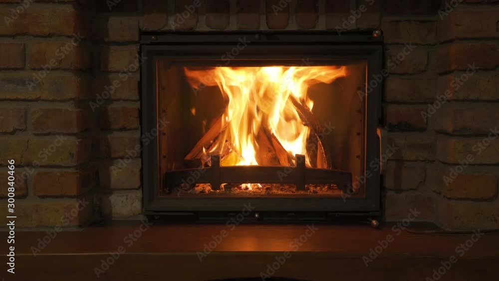 Burning Fireplace - a glowing fire in the stone fireplace to warm at night Burning Fireplace - a glowing fire in the stone fireplace to warm at night