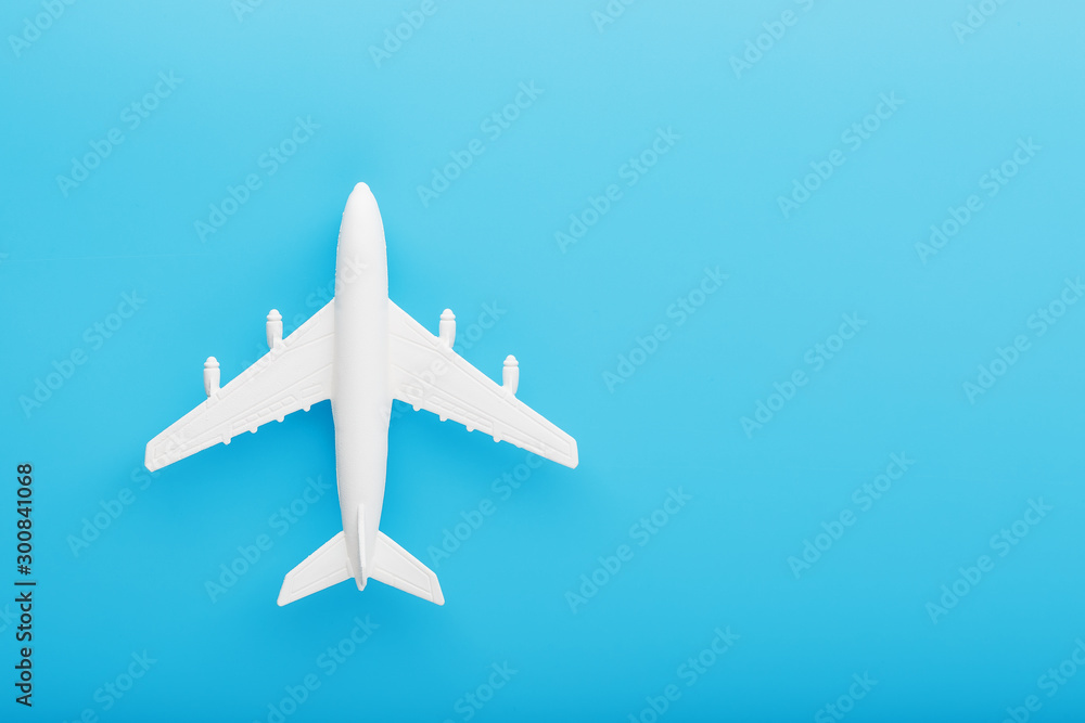 Passenger Model airplane on a blue background. Free space for text.