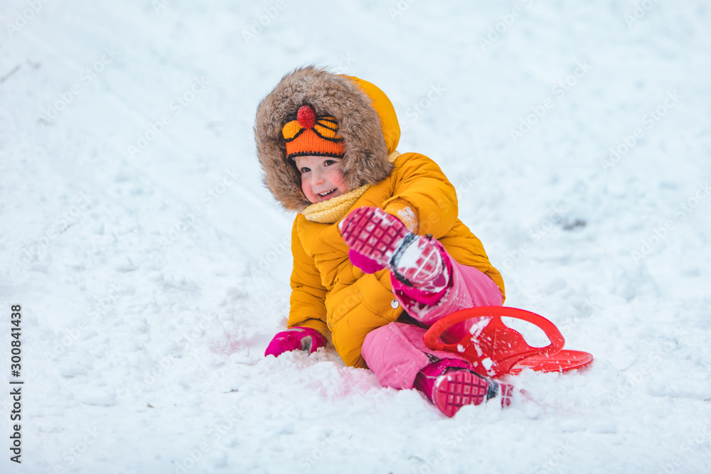 little kid at sledge sliding down by winter hill little kid at sledge sliding down by winter hill