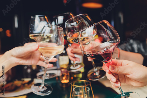 Clinking glasses with alcohol and toasting, party. Fototapet