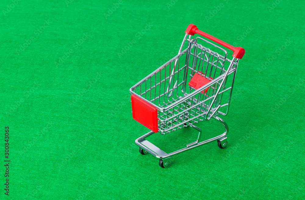 Toy shopping cart on green