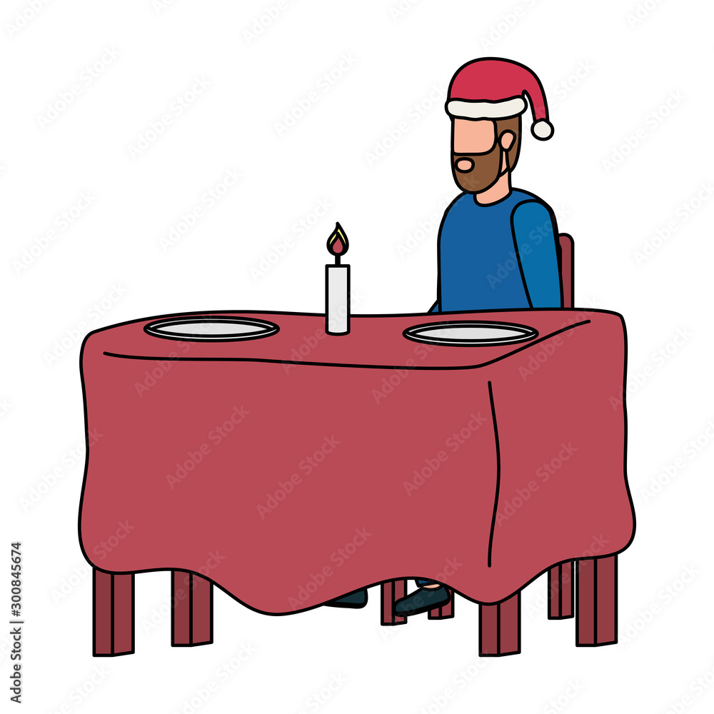 young man with christmas hat in dinner table young man with christmas hat in dinner table
