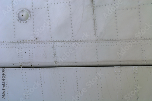 Aluminum sheet and rivet fastening. Aviation background.