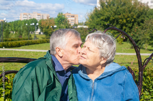 Kissing elderly couple