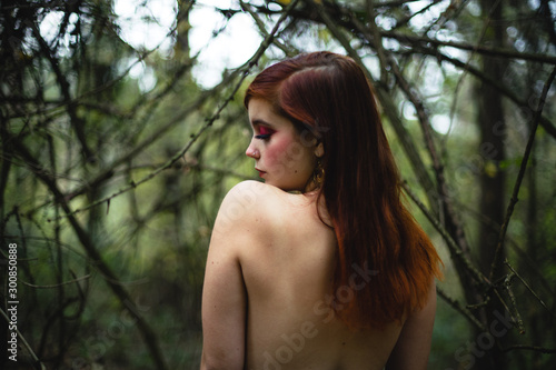 Beautiful Red Haired Girl in Forest 