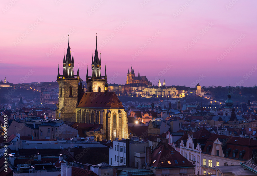 Rooftop view of sunset from the Powder Tower over the Old Town and the Prague Castle.