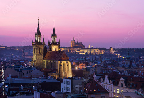 Rooftop view of sunset from the Powder Tower over the Old Town and the Prague Castle.