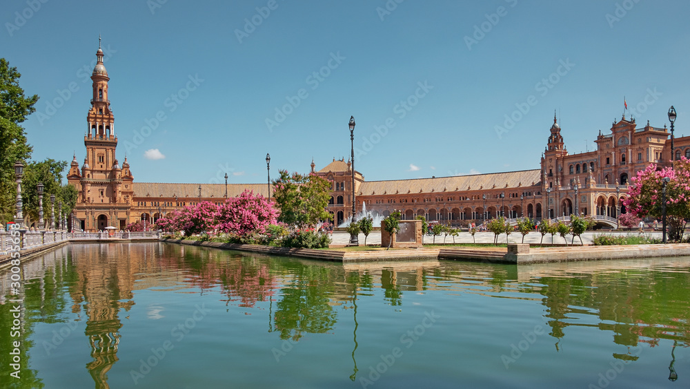 Plaza de Espana, the baroque north tower and the artificial semicircular canal surrounding the plaza, as seen from the basis of the twin south tower, Seville, Andalusia, Spain 