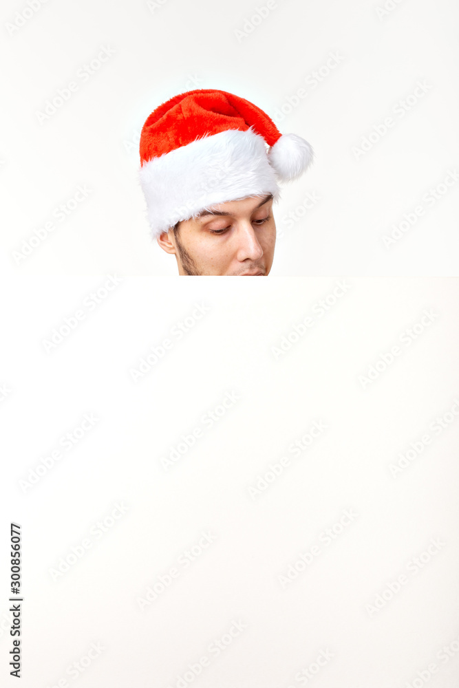 Santa man in christmas red hat for new year holiday with white paper sheet isolated on white background, copy space Santa man in christmas red hat for new year holiday with white paper sheet isolated on white background, copy space