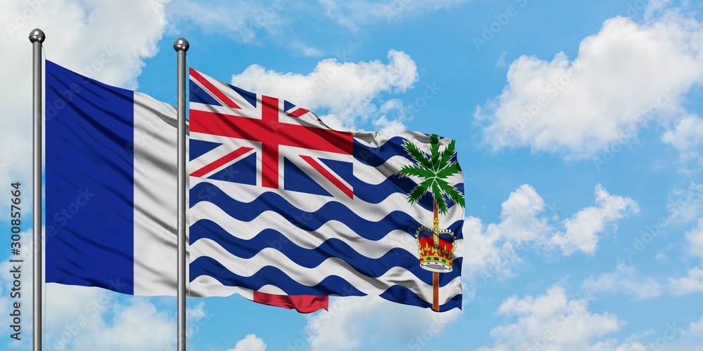 France and British Indian Ocean Territory flag waving in the wind against white cloudy blue sky together. Diplomacy concept, international relations.