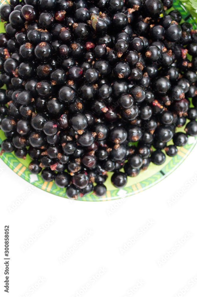 Black currant on a plate. Background. Photo. Black currant on a plate. Background. Photo.