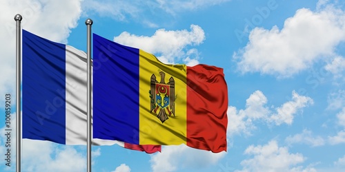 France and Moldova flag waving in the wind against white cloudy blue sky together. Diplomacy concept, international relations.