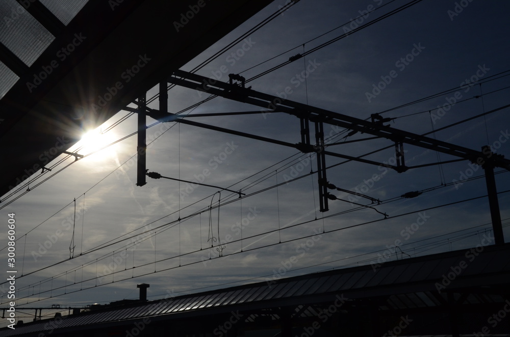 silhouette of powercables at a train station silhouette of powercables at a train station
