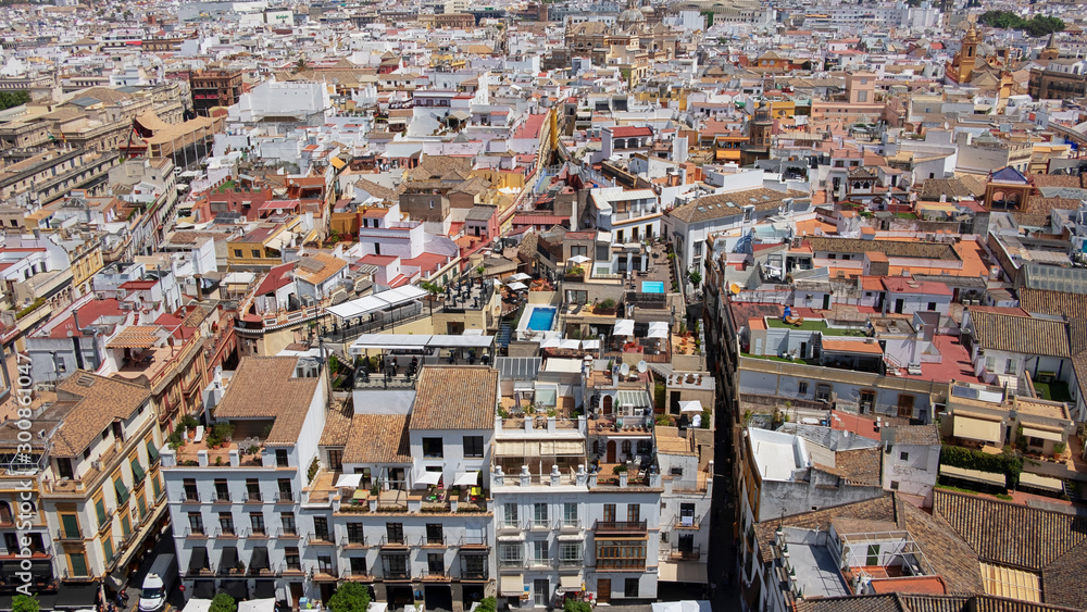 Panoramic aerial views of the city: buildings, streets, rooftops as seen from Giralda tower, part of the Seville Cathedral also known as Catedral de Santa María de la Sede de Sevilla, Andalusia, Spain