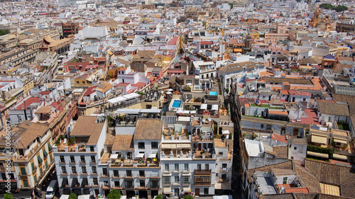 Panoramic aerial views of the city: buildings, streets, rooftops as seen from Giralda tower, part of the Seville Cathedral also known as Catedral de Santa María de la Sede de Sevilla, Andalusia, Spain
