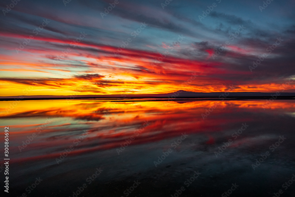 Fototapeta Sunset with cloudscape reflection at Chaxa lagoon, Atacama