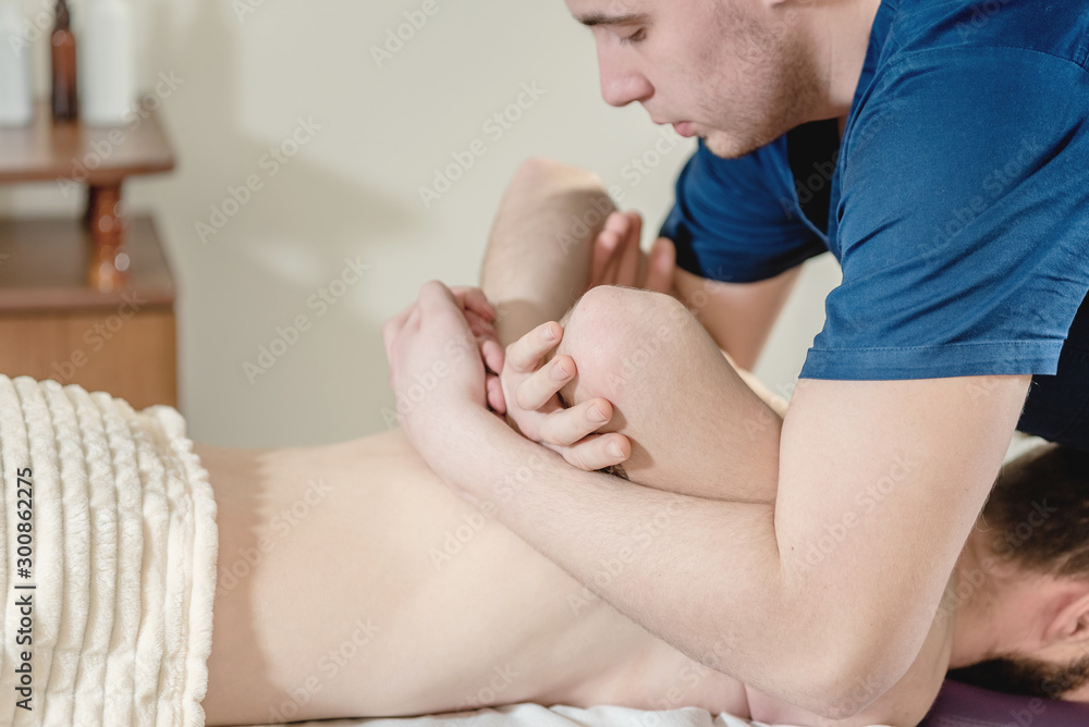 Masseur makes massage to the patient. Massage in a medical institution. Masseur makes massage to the patient. Massage in a medical institution.