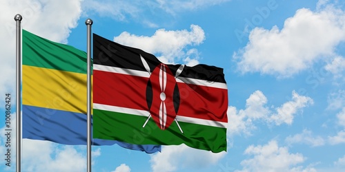 Gabon and Kenya flag waving in the wind against white cloudy blue sky together. Diplomacy concept, international relations.