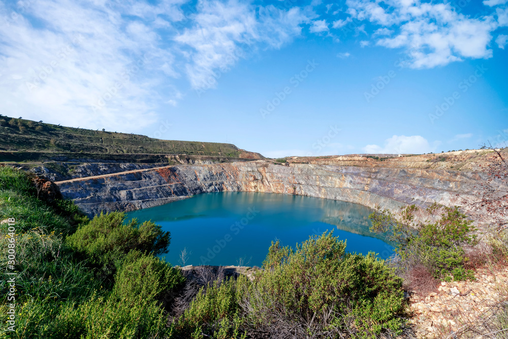 Fantastic view of Open Pit Mining landscape on blue sky.