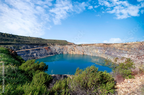 Fantastic view of Open Pit Mining landscape on blue sky.