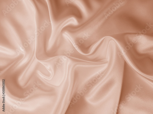 Beautiful smooth elegant wavy beige / light brown satin silk luxury cloth fabric texture, abstract background design. Copy space. photo