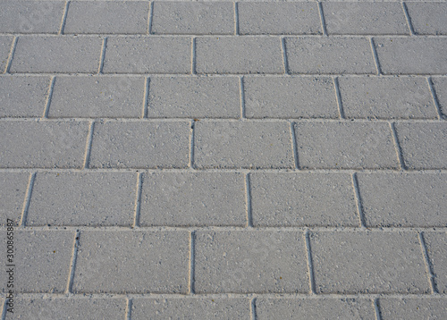 Texture of concrete walkway brick floor in perspective closeup background.