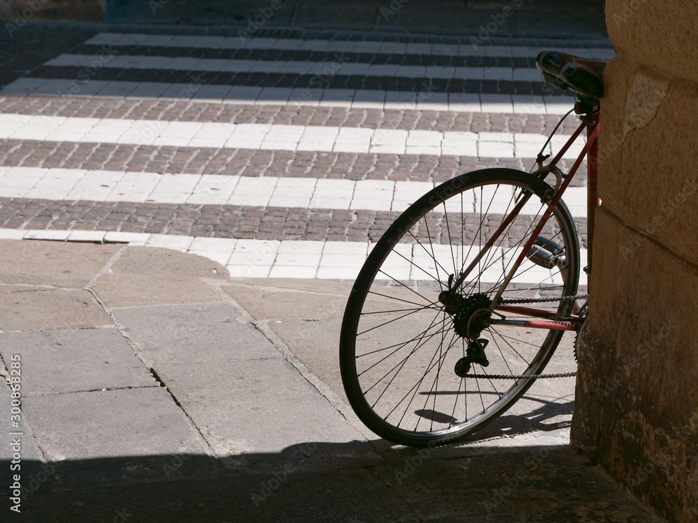 a bicycle is standing against a wall in an arch. Italy Vicenza a bicycle is standing against a wall in an arch. Italy Vicenza