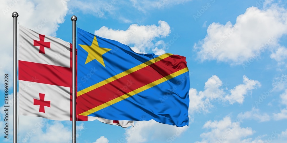 Georgia and Congo flag waving in the wind against white cloudy blue sky together. Diplomacy concept, international relations.