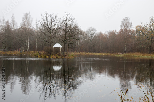 Autumn panorama of the pond with a gazebo in the Park with oaks. Smolensk region, Russia.