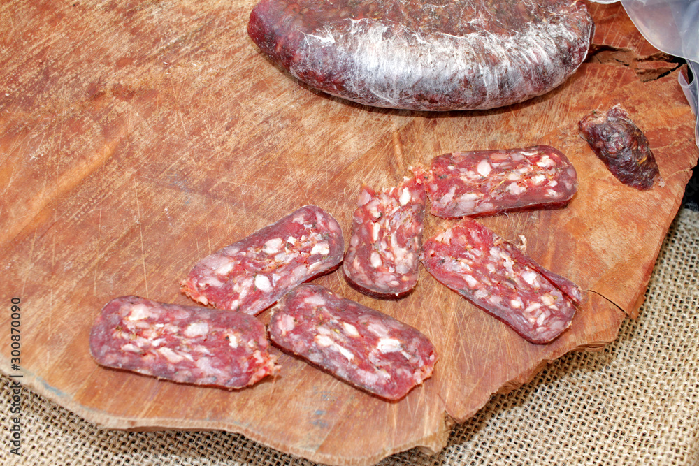 Flat dry sausages. Delicatessen salami cover photo. Food pattern. Flat dry sausages. Delicatessen salami cover photo. Food pattern.