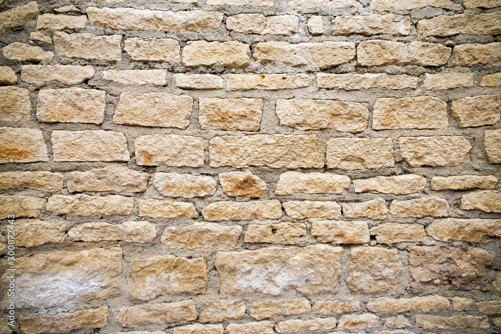 Background of an ancient wall made of natural stone. Background of an ancient wall made of natural stone.