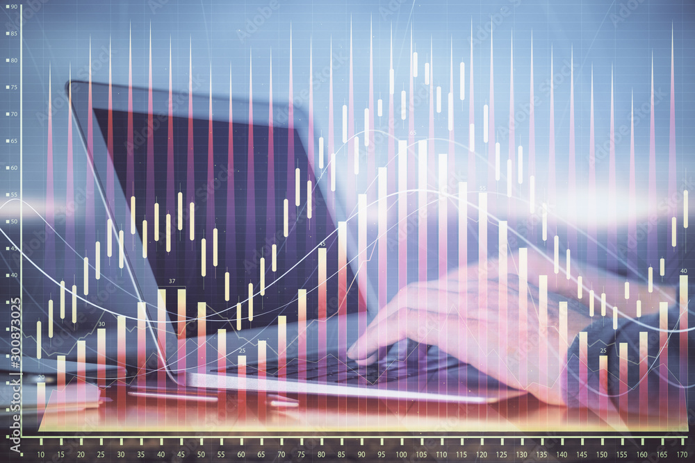 Double exposure of man's hands writing notes with laptop of stock market with forex graph background. Top View. Concept of research and trading. Double exposure of man's hands writing notes with laptop of stock market with forex graph background. Top View. Concept of research and trading.